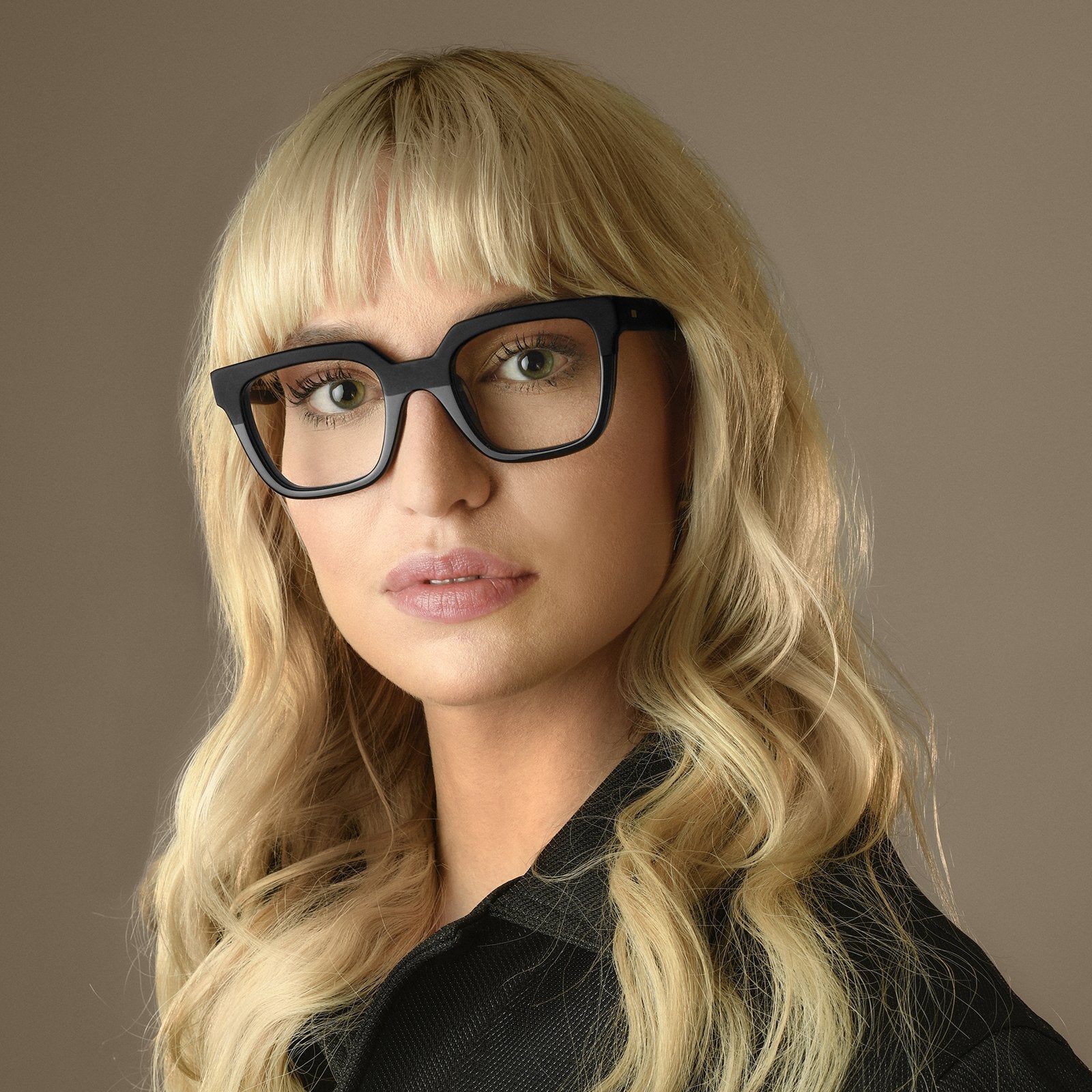 Model wearing Cubo Eyewear’s Franca frame in a studio portrait, showcasing the bold handcrafted design