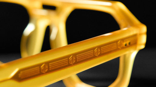 Close-up of a Cubo Eyewear frame in yellow Mazzucchelli acetate, showing precision-cut temple detailing