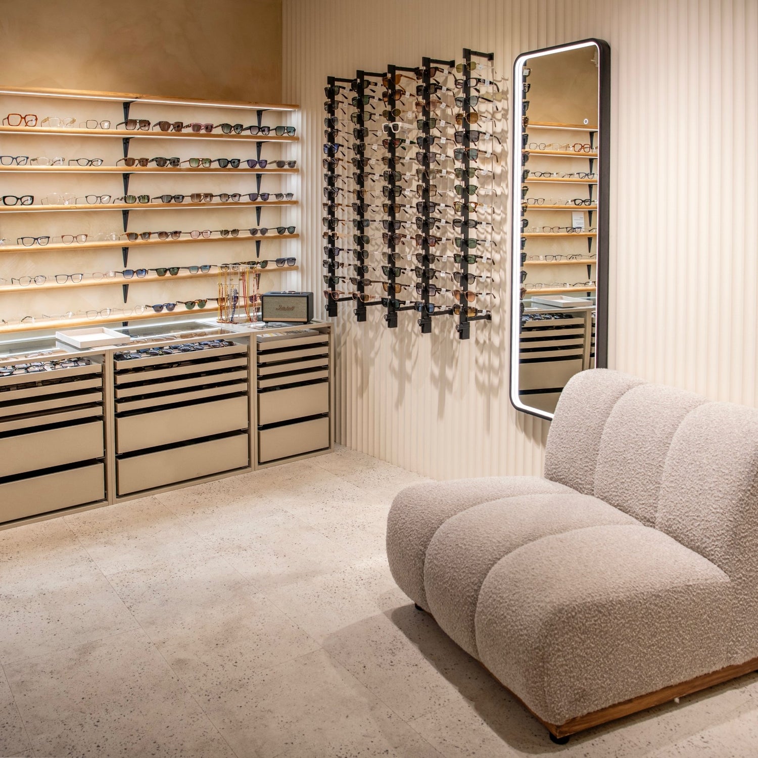Inside the Glasseslab Beckenham store featuring eyewear displays, sunglasses racks and a modern seating area.