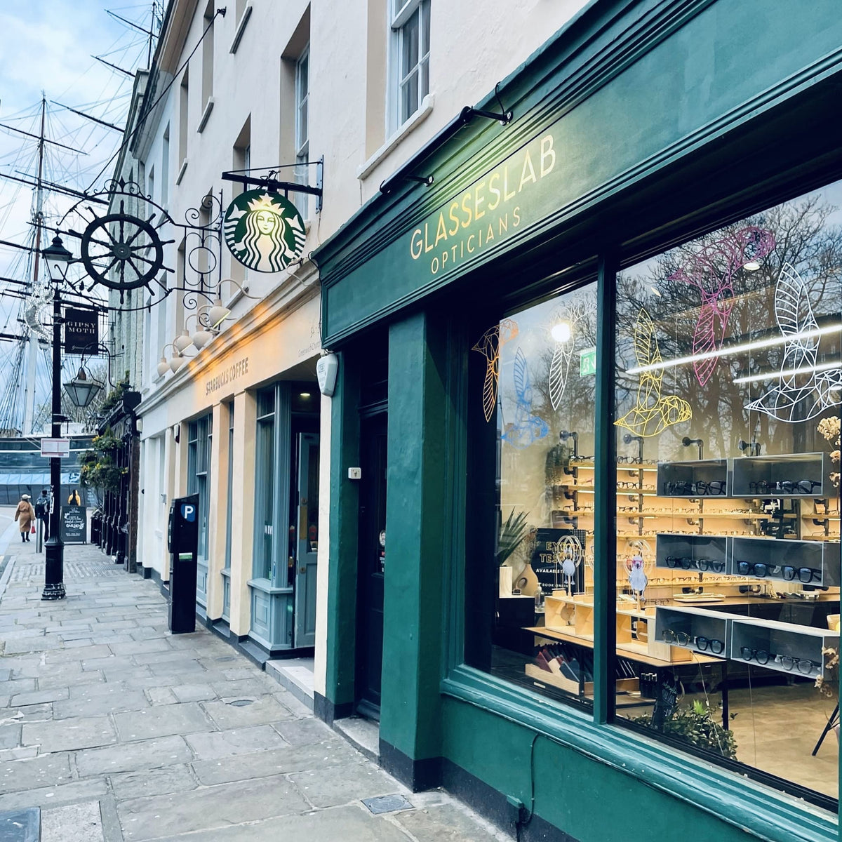 Glasseslab Greenwich storefront near the Cutty Sark, showing its green window frames.