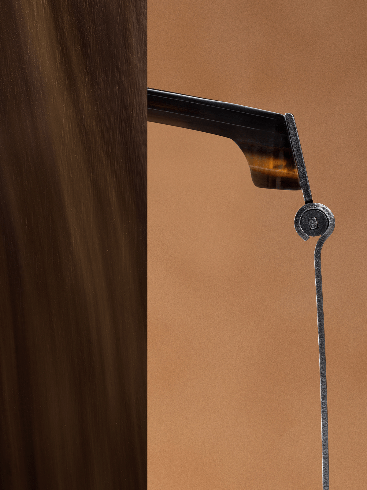 Close-up of a LINDBERG Buffalo Titanium frame showing the slim titanium temple and horn-inspired front detail.